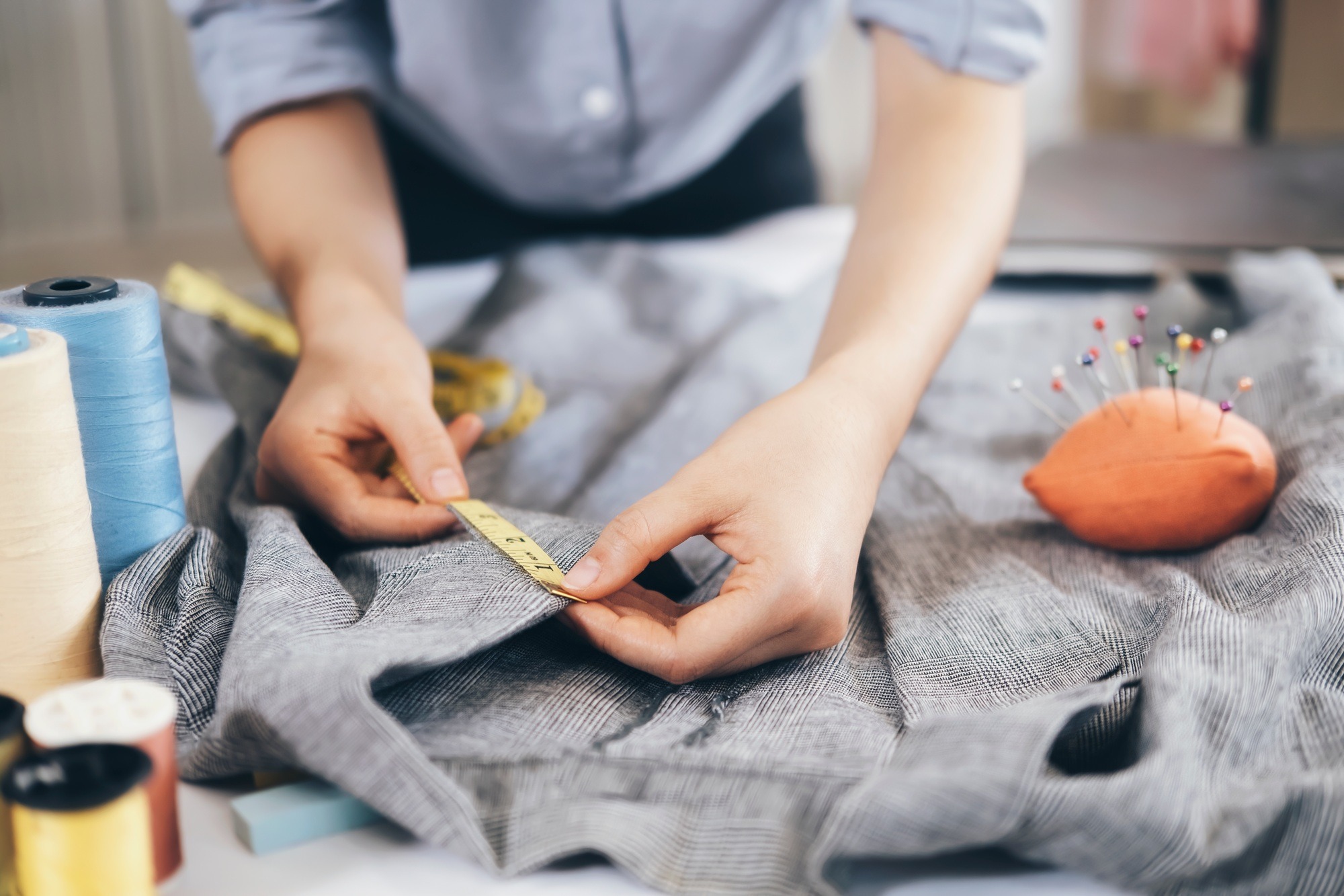 The tailor taking measurements of jacket